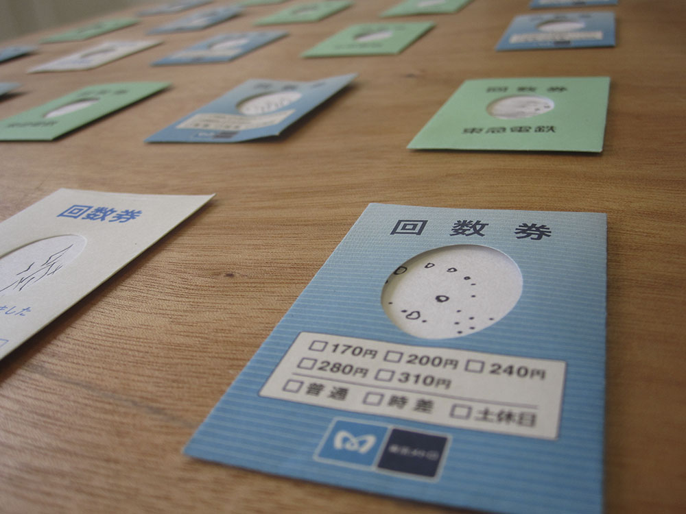 Image of Tokyo train ticket envelopes with tiny drawings inside