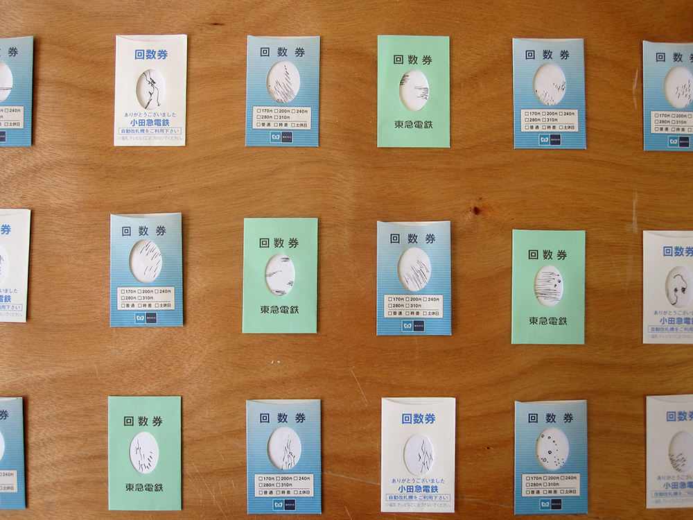Image of Tokyo train ticket envelopes with tiny drawings inside